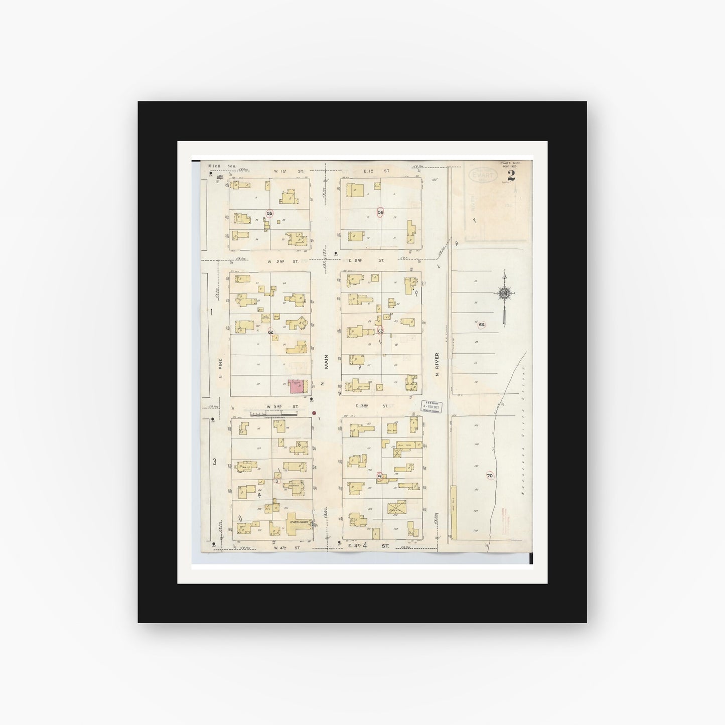 Old map wall art mockup — black gallery frame with white mat — Sanborn Fire Insurance Map from Evart, Osceola County, Michigan (1942), Sheet #0002