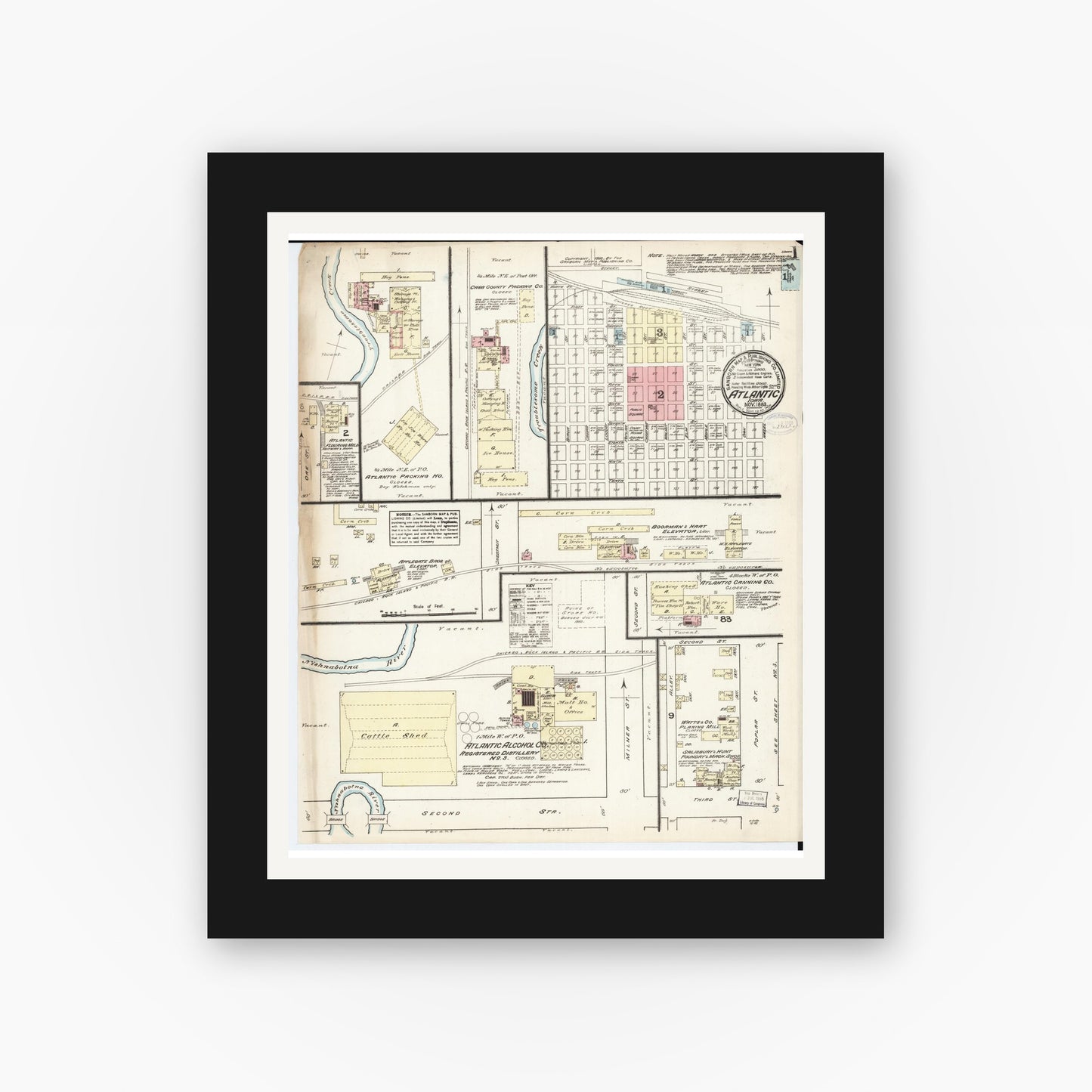 Old map wall art mockup — black gallery frame with white mat — Sanborn Fire Insurance Map from Atlantic, Cass County, Iowa (1883) — Complete Set