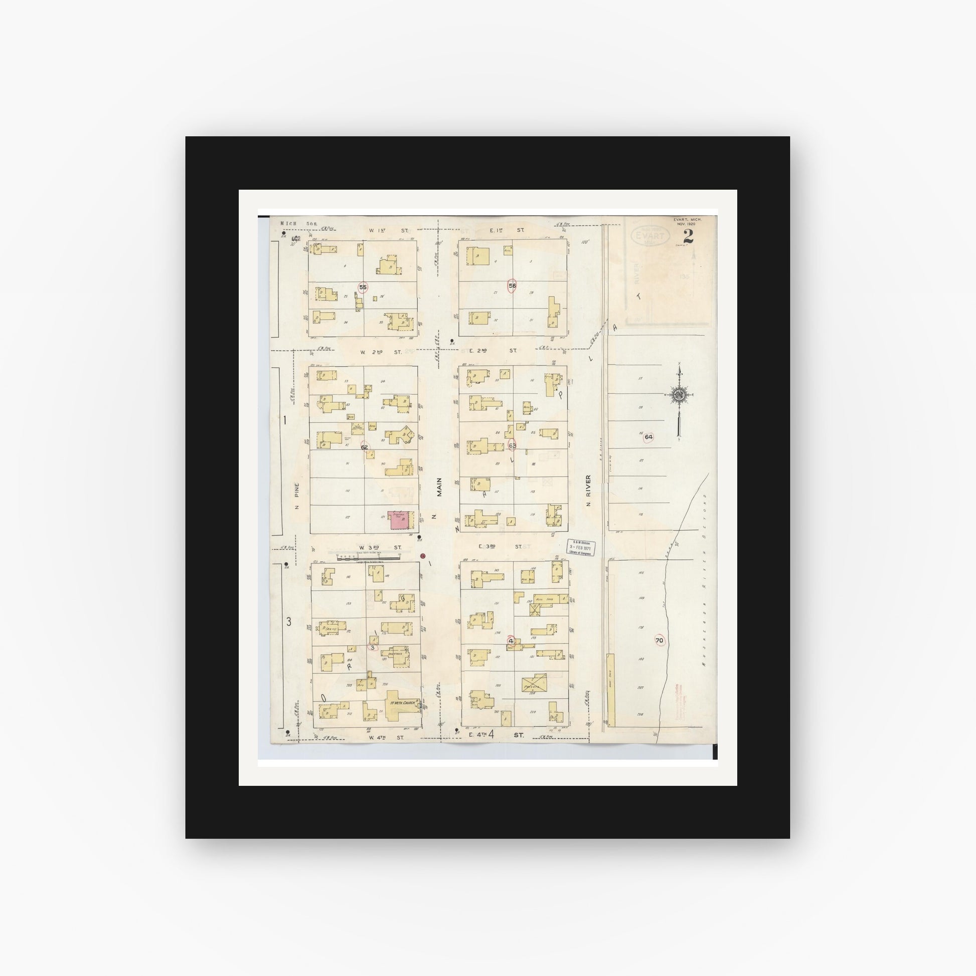 Old map wall art mockup — black gallery frame with white mat — Sanborn Fire Insurance Map from Evart, Osceola County, Michigan (1942), Sheet #0002