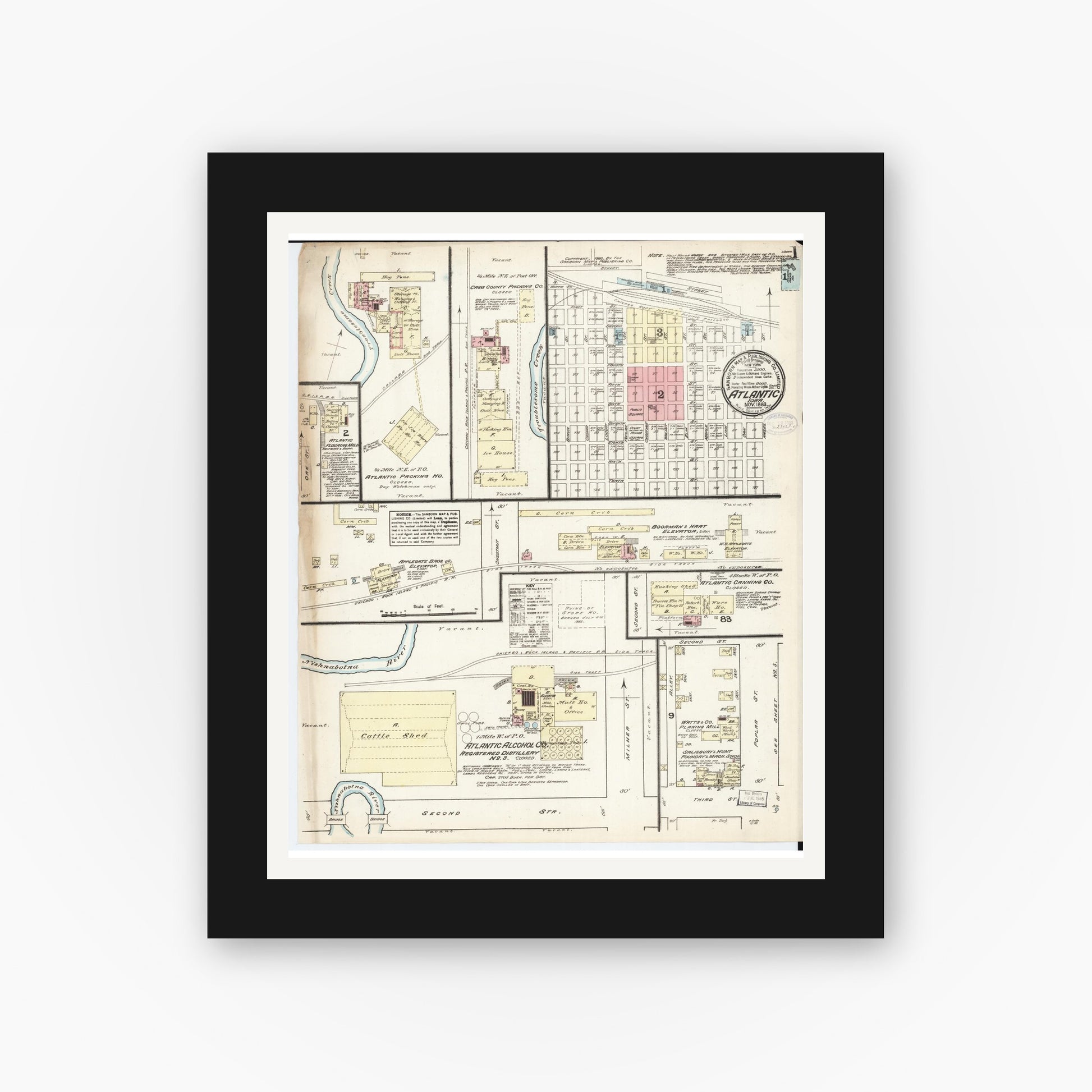 Old map wall art mockup — black gallery frame with white mat — Sanborn Fire Insurance Map from Atlantic, Cass County, Iowa (1883) â€” Complete Set