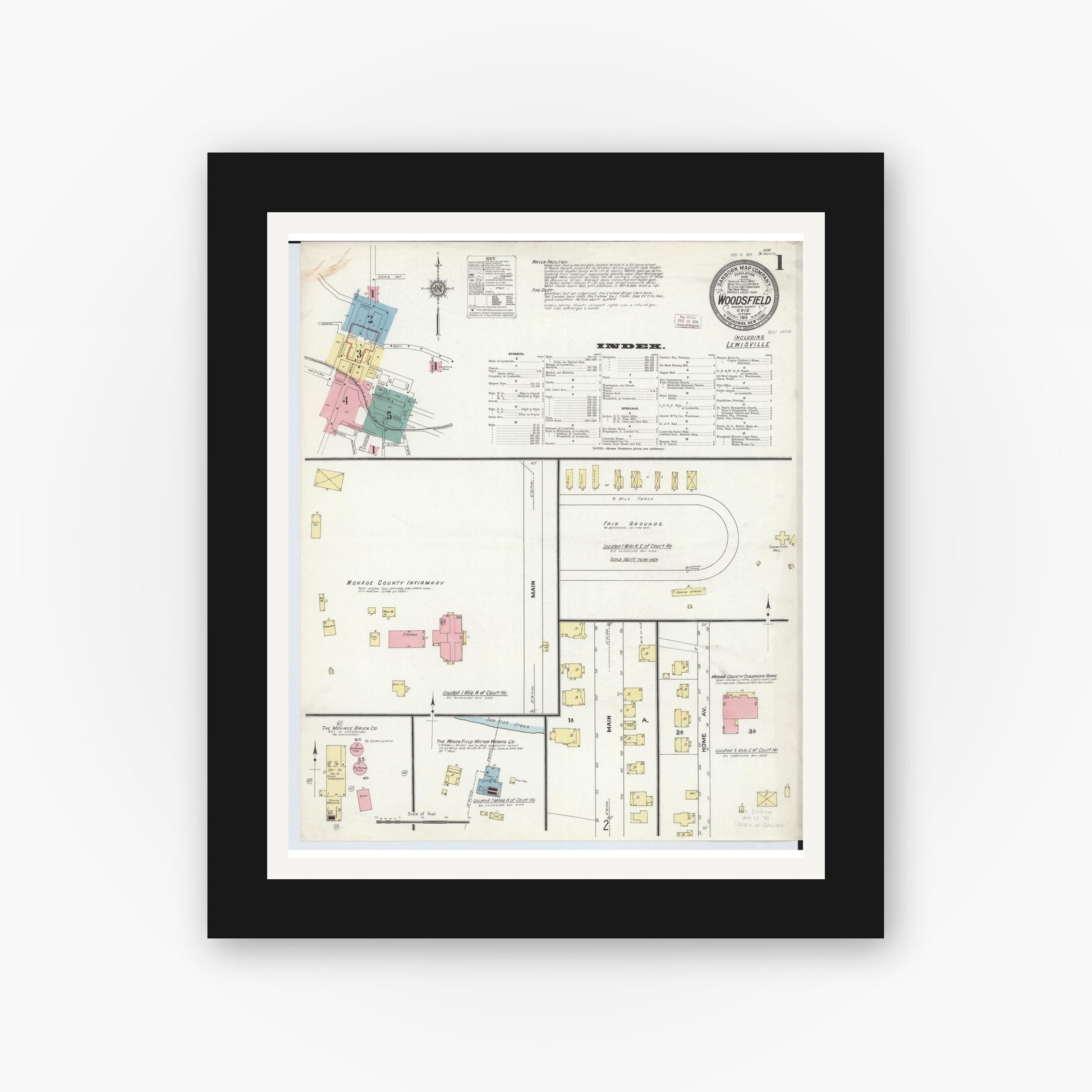 Old map wall art mockup — black gallery frame with white mat — Sanborn Fire Insurance Map from Woodsfield, Monroe County, Ohio (1911), Sheet #0001