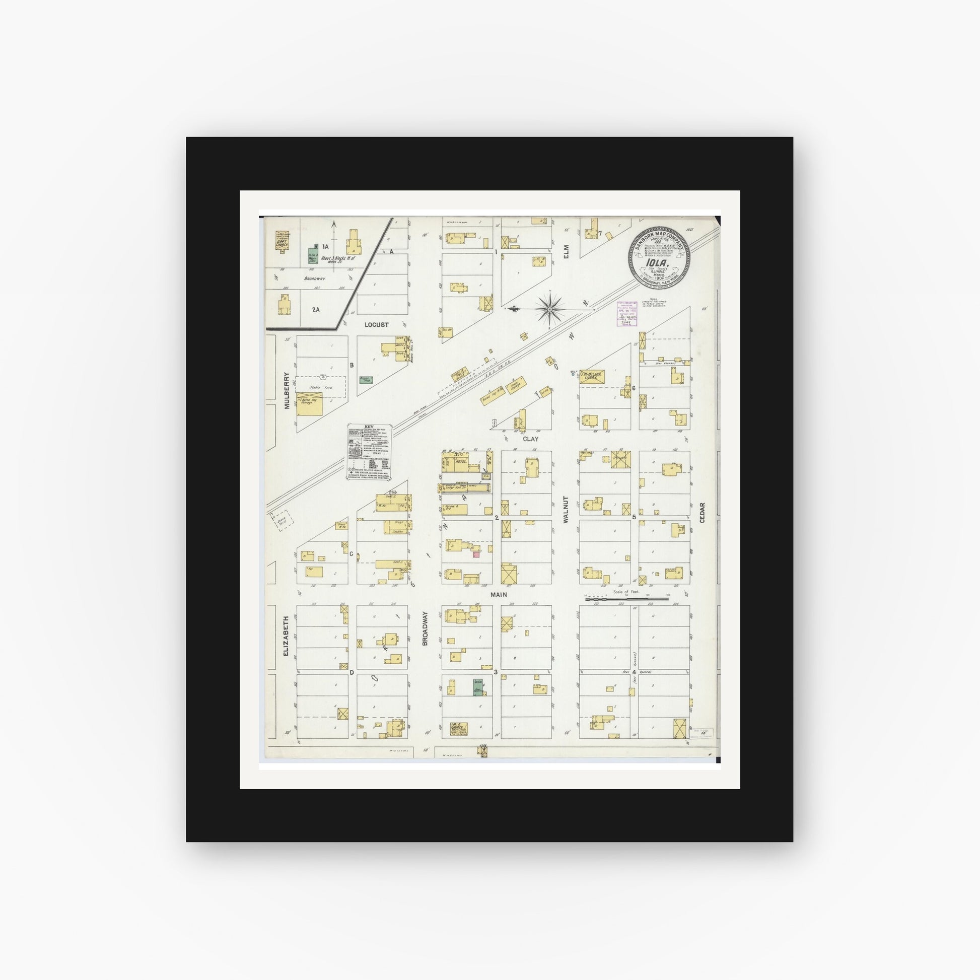 Old map wall art mockup — black gallery frame with white mat — Sanborn Fire Insurance Map from Iola, Clay County, Illinois (1902), Sheet #0001