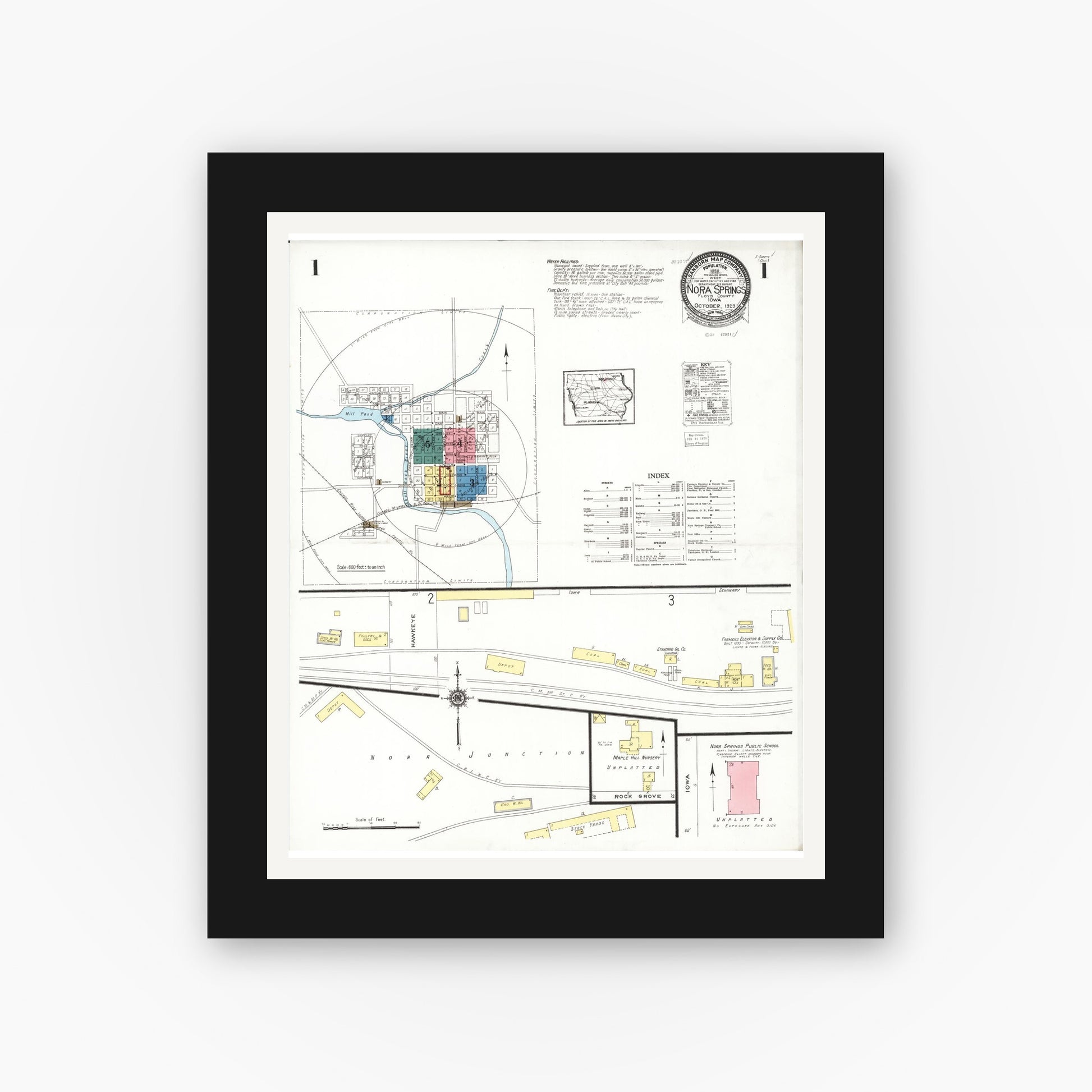 Old map wall art mockup — black gallery frame with white mat — Sanborn Fire Insurance Map from Nora Springs, Floyd County, Iowa (1923) â€” Complete Set