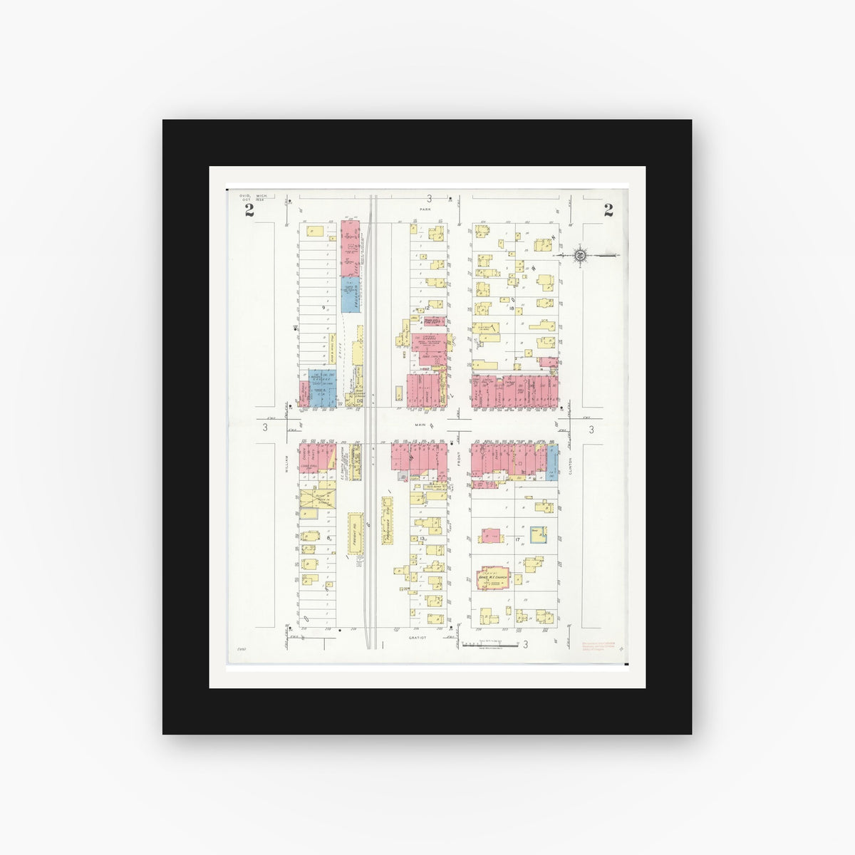 Old map wall art mockup — black gallery frame with white mat — Sanborn Fire Insurance Map from Ovid, Clinton County, Michigan (1934), Sheet #0002