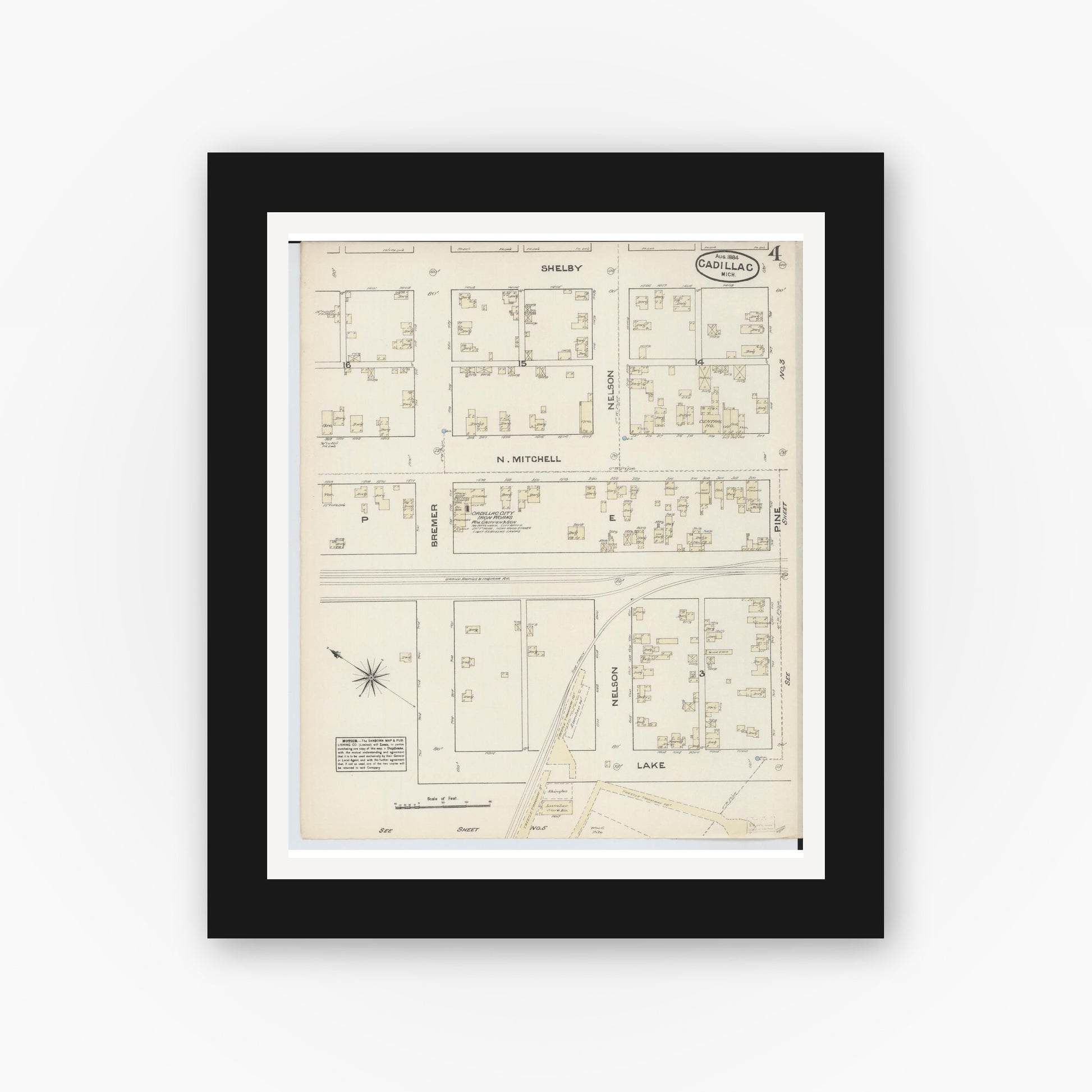 Old map wall art mockup — black gallery frame with white mat — Sanborn Fire Insurance Map from Cadillac, Wexford County, Michigan (1884), Sheet #0004