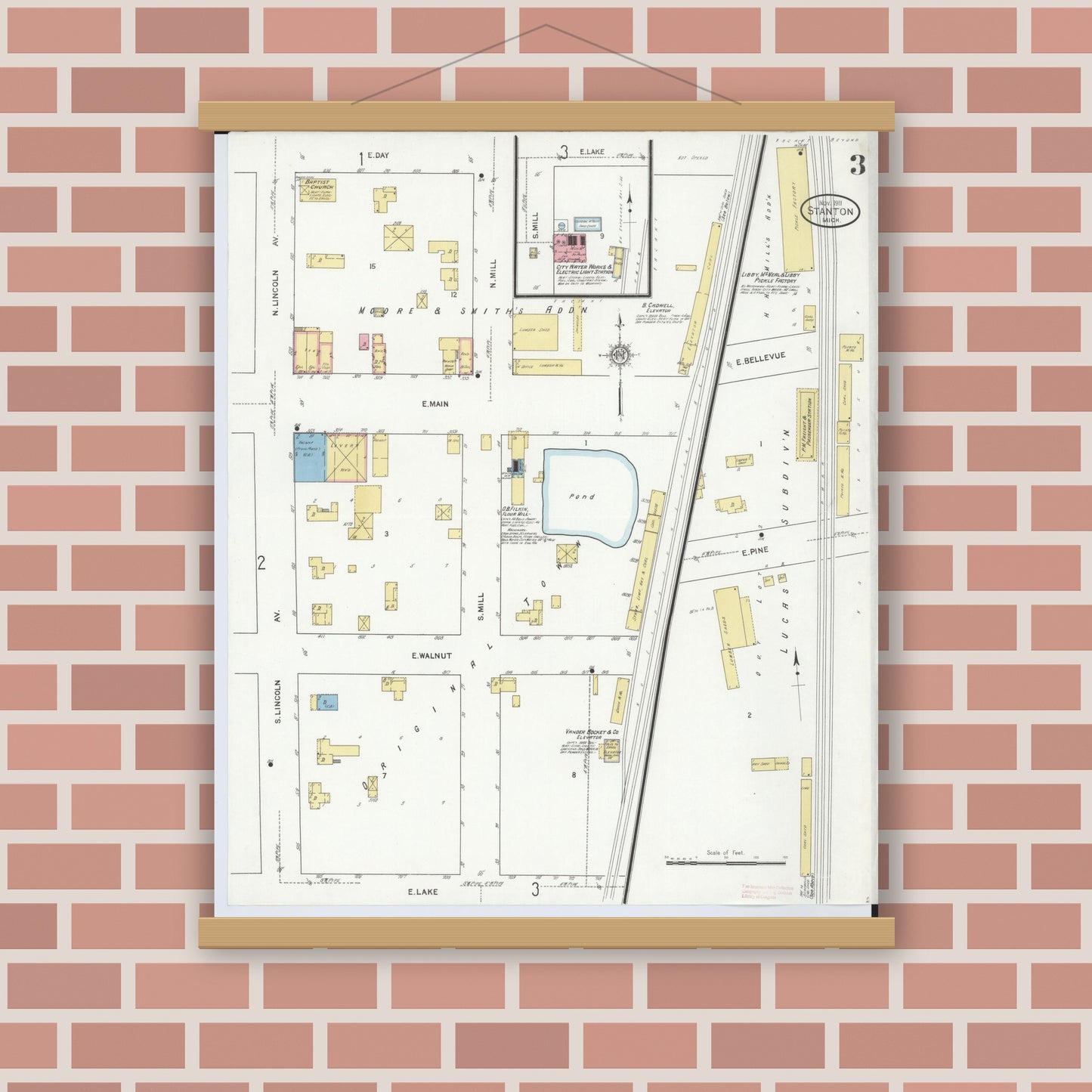 Old map wall art mockup — magnetic wood frame on brick wall — Sanborn Fire Insurance Map from Stanton, Montcalm County, Michigan (1911), Sheet #0003